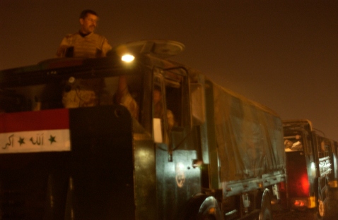 Iraqi dude waits to start the convoy in his truck.